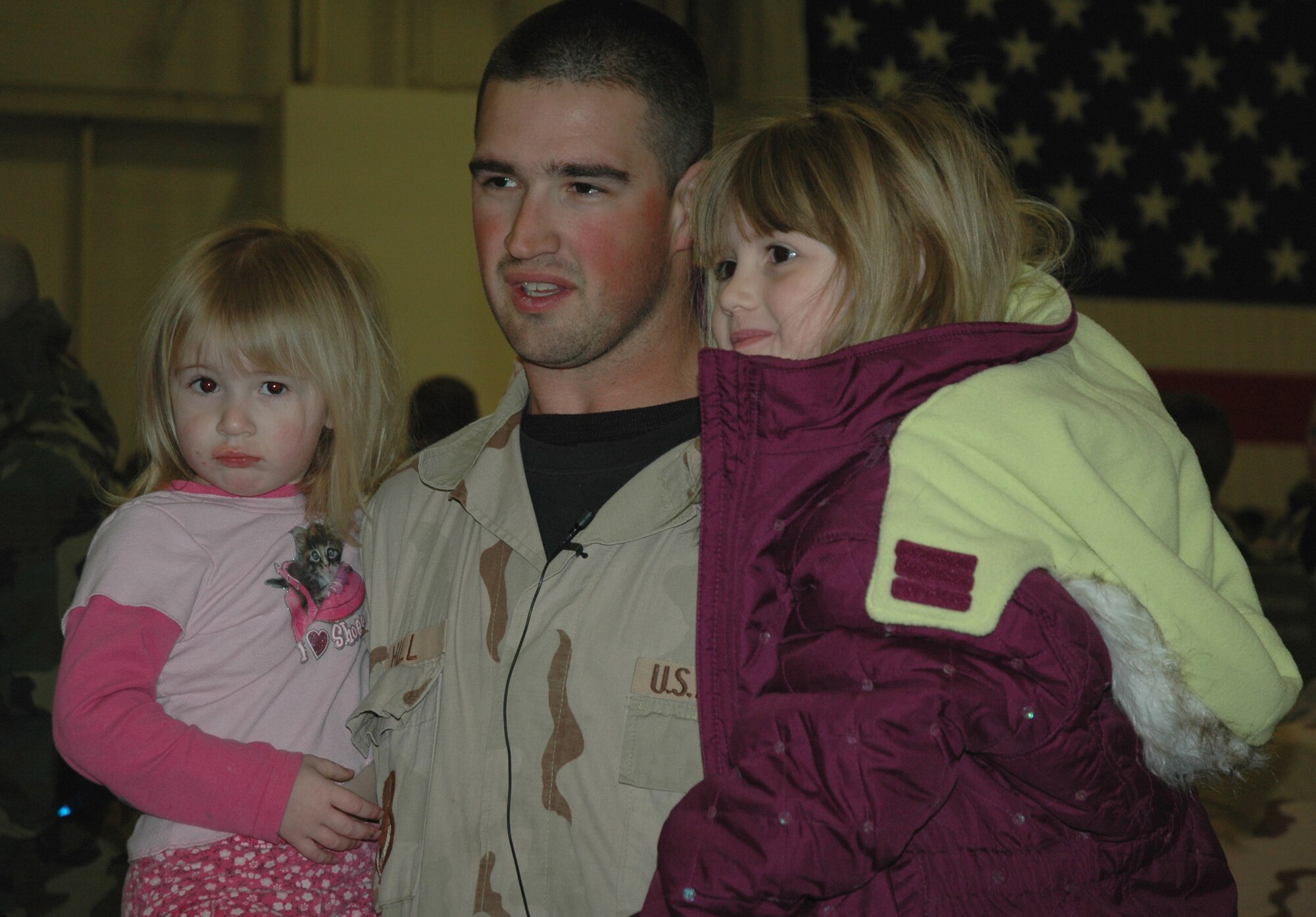 Staff Sgt. Joshua Hill greets his two daughters after returning to Mountain Home Air Force Base Jan. 26 from a four-month deployment to Iraq.  Sergeant Hill, a maintainer with the 726th Air Control Squadron, was deployed with nearly 175 other Airmen from his squadron since Sept. 2006.