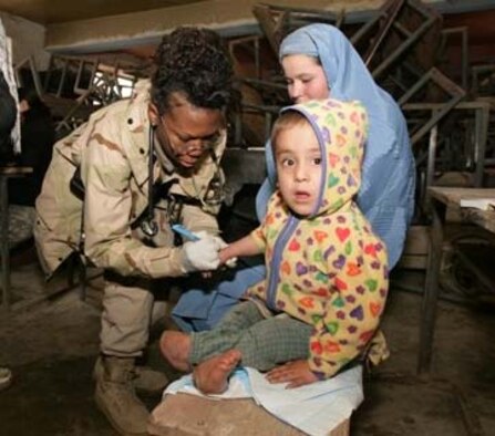 1st Lt. Barbara Acevedo examins a child believed to have polio. Lieutenant Acevedo is assigned to 28th Medical Group. (U.S. Air Force photo/Capt. Stacie N. Shafran)