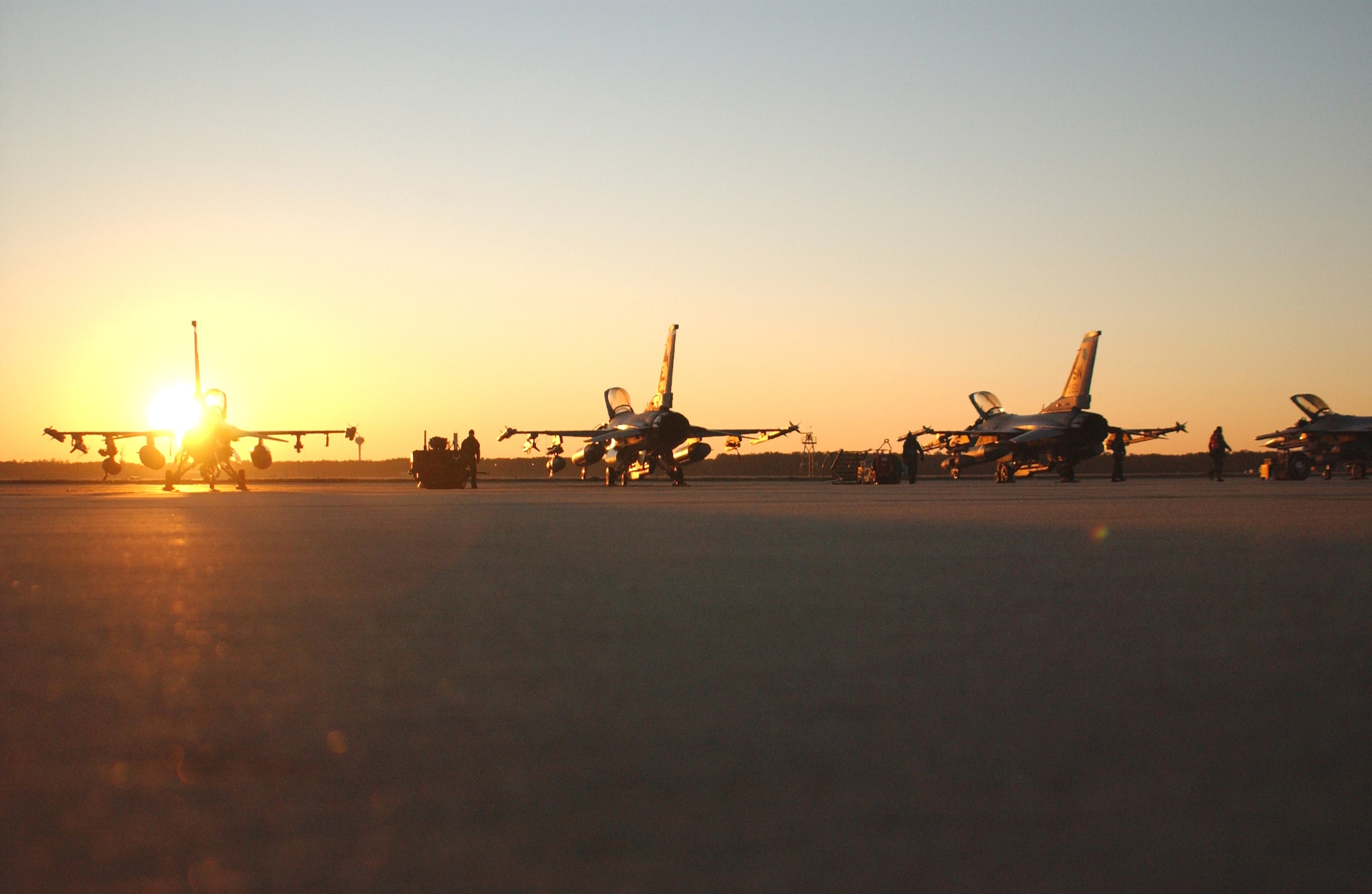 F-16 Fighting Falcons assigned to the 20th Fighter Wing sit on a ramp awaiting generation in support of Operational Readiness Exercise Sea Lion 07-03 Jan. 26 at Shaw Air Force Base, S.C. Exercises prepare Airmen for future deployments. Shaw AFB is home to the Air Force?s largest combat F-16 wing -- the 20th FW -- whose mission is to provide, project and sustain combat-ready air forces. (U.S. Air Force photo/Staff Sgt. Nathan Bevier) 

