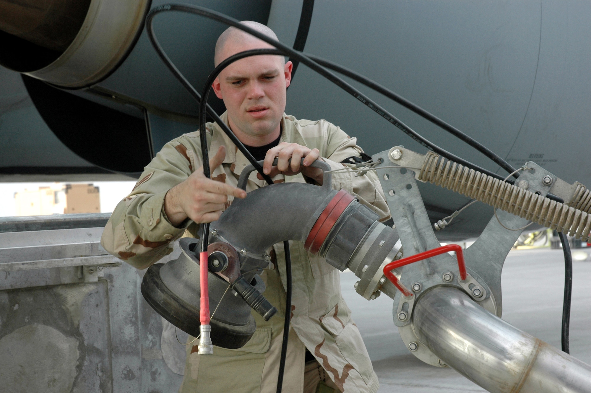 Airman 1st Class Robert Walsh prepares to refuel the first KC-135 Stratotanker through the new hydrant system Jan. 24 in Southwest Asia. Airman Walsh is assigned to the 379th Expeditionary Logistics Readiness Squadron Petroleum, Oil and Lubricants Flight. (U.S. Air Force photo/Senior Airman Erik Hofmeyer)