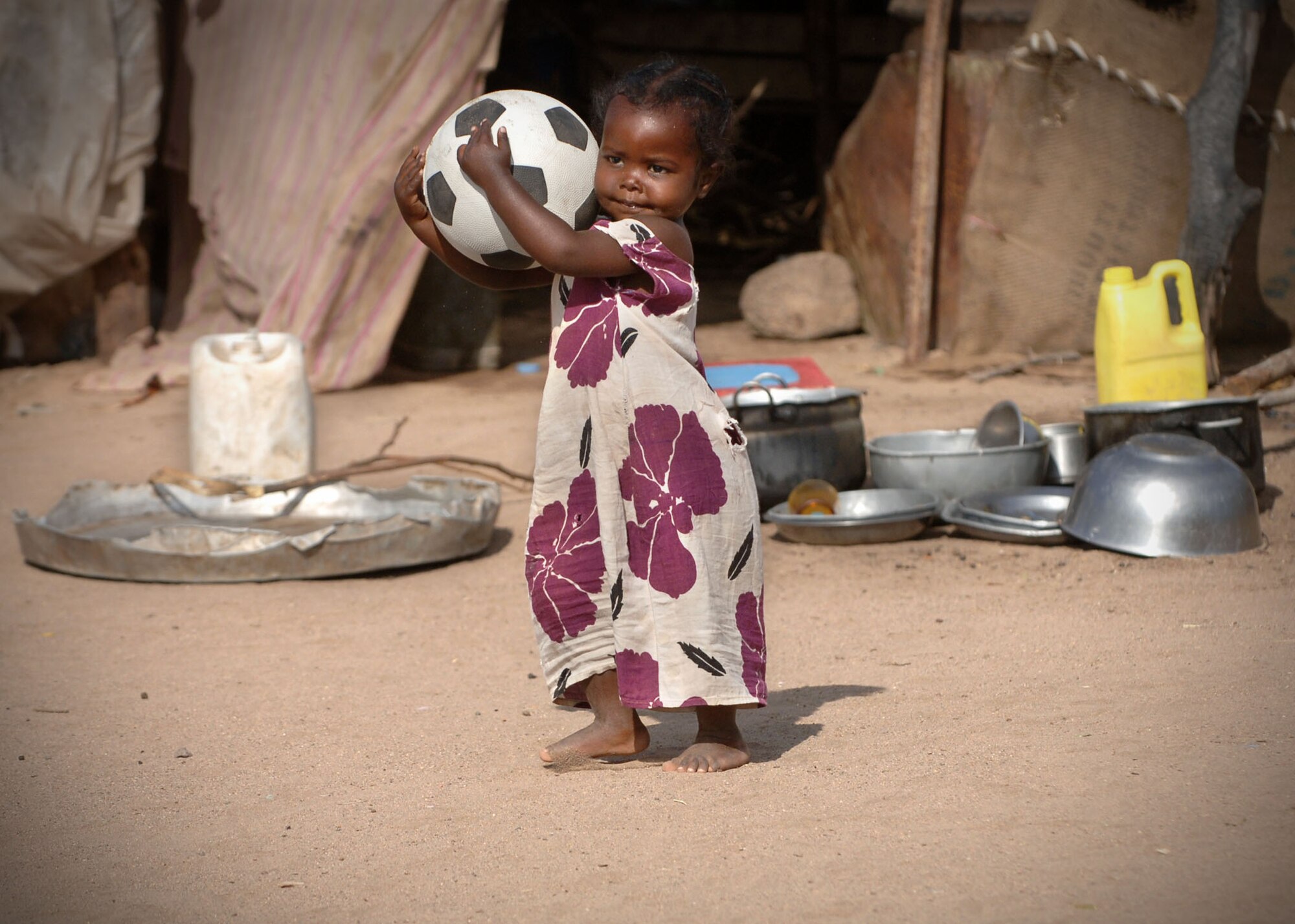 A thankful child plays with a soccer ball she received from US service members through “Operation Play.”  Operation Play is designed to provide school children on the Horn of Africa with soccer balls and is being implemented by former East Carolina University soccer player, Lt. Col. Joe Atkins, 314th Mission Support Squadron commander.