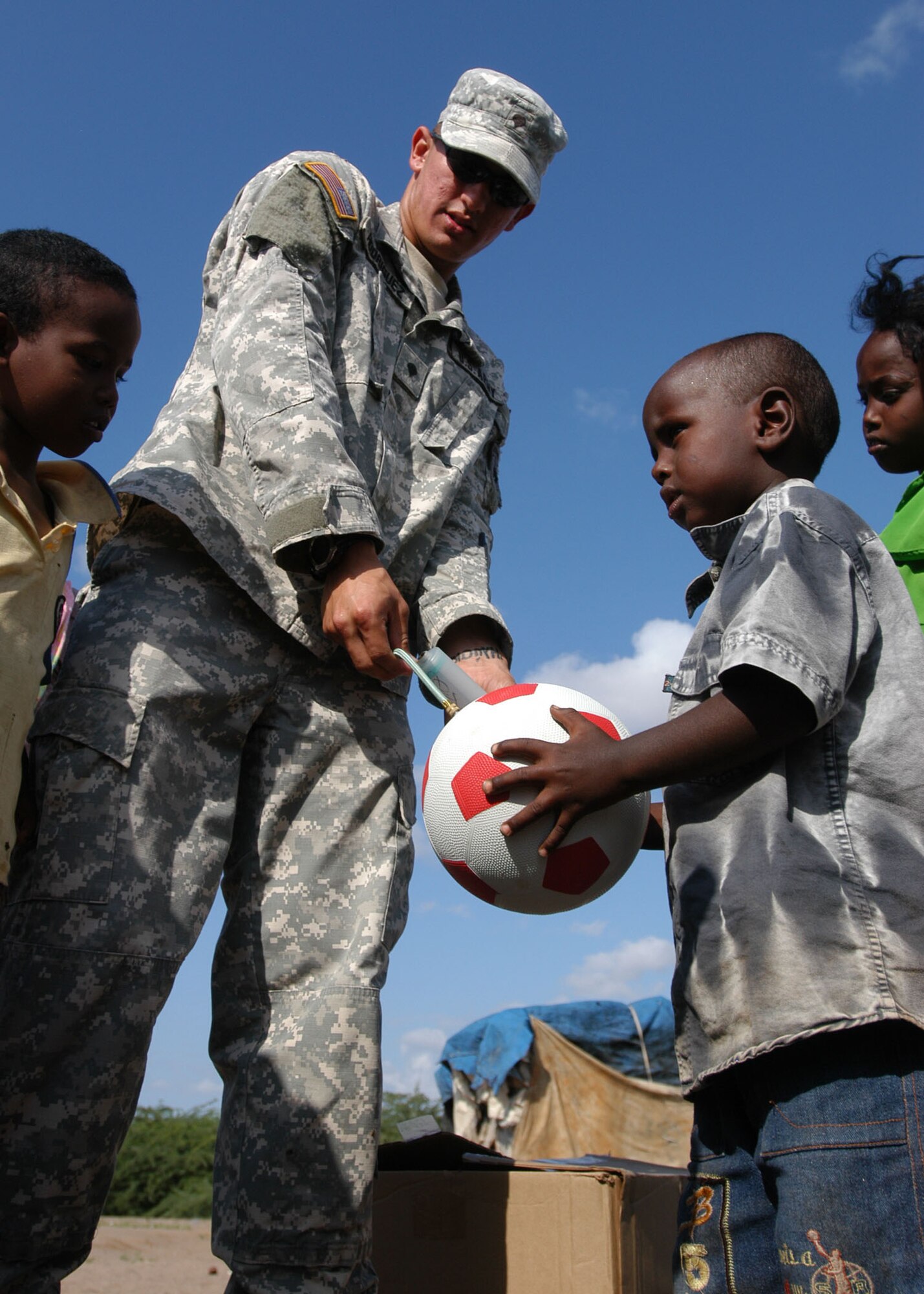 An Army soldier, deployed to the Horn of Africa, inflates a soccer ball as part of “Operation Play.” Operation Play is designed to provide school children on the Horn of Africa with soccer balls and is being implemented by former East Carolina University soccer player, Lt. Col. Joe Atkins, 314th Mission Support Squadron commander.