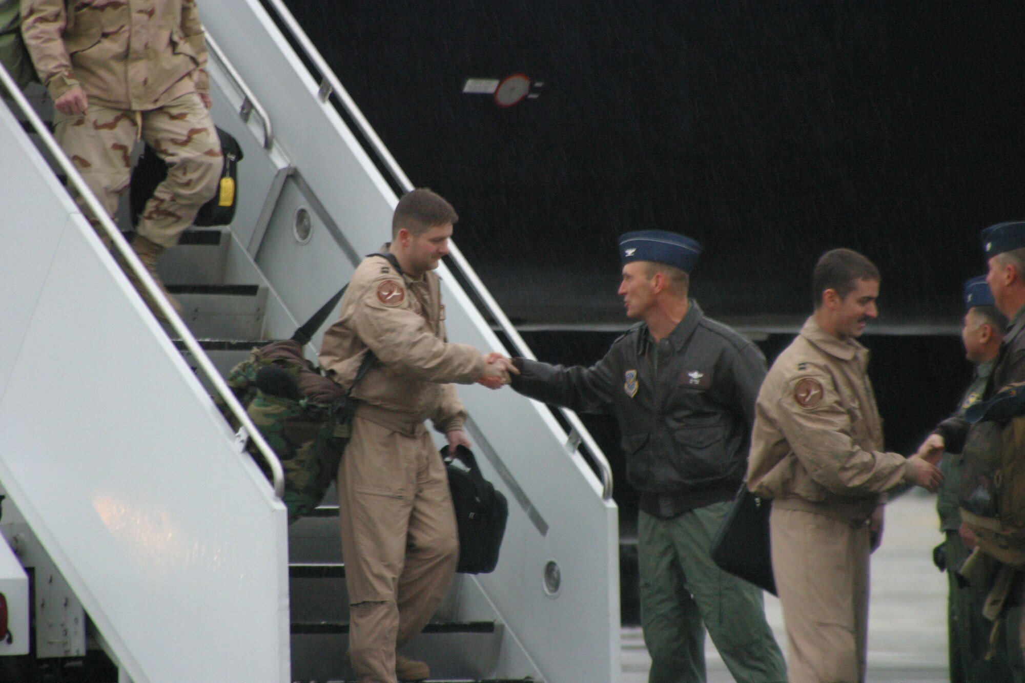 Col. Timothy Zadalis, 43rd Airlift Wing Commander, greets Airmen as the exit an aircraft. More than 250 Airmen returned home from a four-month deployment to Afghanistan. 