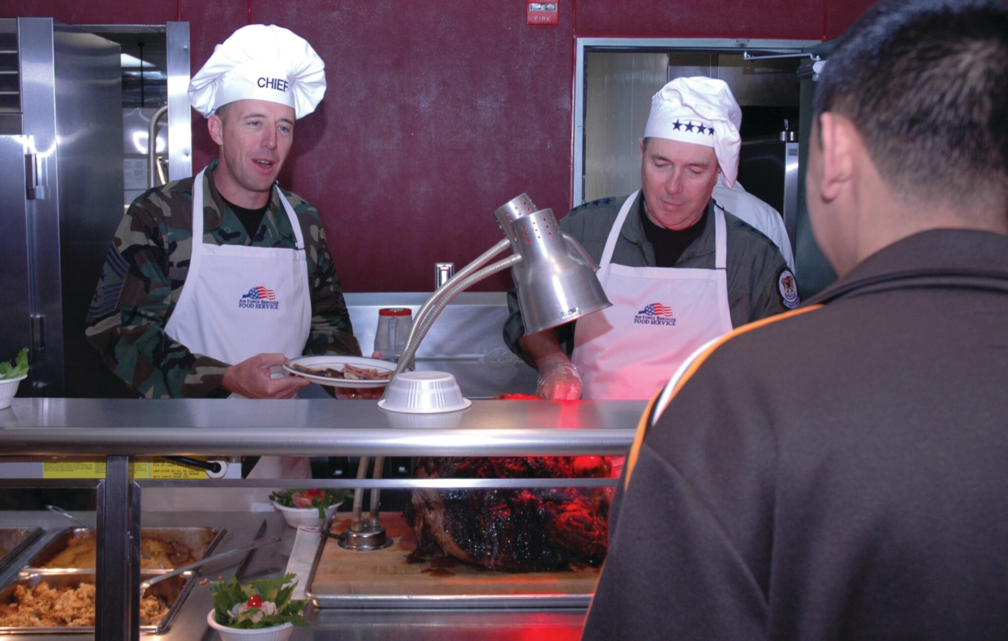 OSAN AIR BASE, Republic of Korea --  Gen. Paul V. Hester (right), Pacific Air Forces commander, and Chief Master Sgt. Anthony Bishop, PACAF command chief master sergeant, served Thanksgiving meals to Team Osan Thursday. (U.S> Air Force photo by 1st Lt. Kevin Coffman)