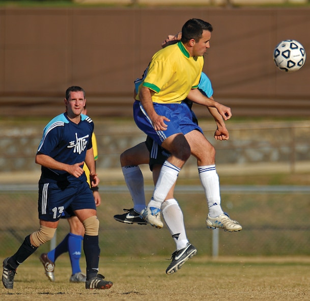 OSAN AIR BASE, Republic of Korea --  Anthony Pinto, 621st Air Control Squadron, jousts with a Cheongju Tiger defender. Pinto is with the Osan Mustangs, Osan's soccer club. (Photo by Staff Sgt. Joshua Klahn)