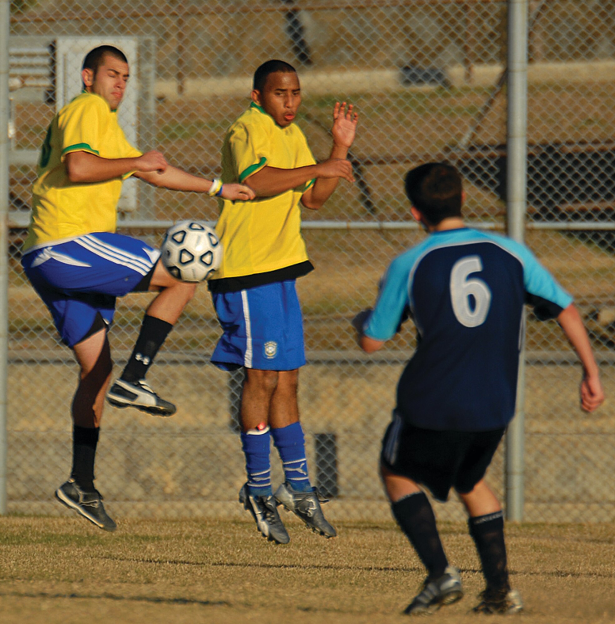OSAN AIR BASE, Republic of Korea --  Chris De La Campa, 5th Reconnaissance Squadron and Jack James, 51st Dental Squadron, block a goal attempt by a Cheongju Tiger. Both La Campa and James are with the Osan Mustangs, Osan's soccer club. (Photo by Staff Sgt. Joshua Klahn) 