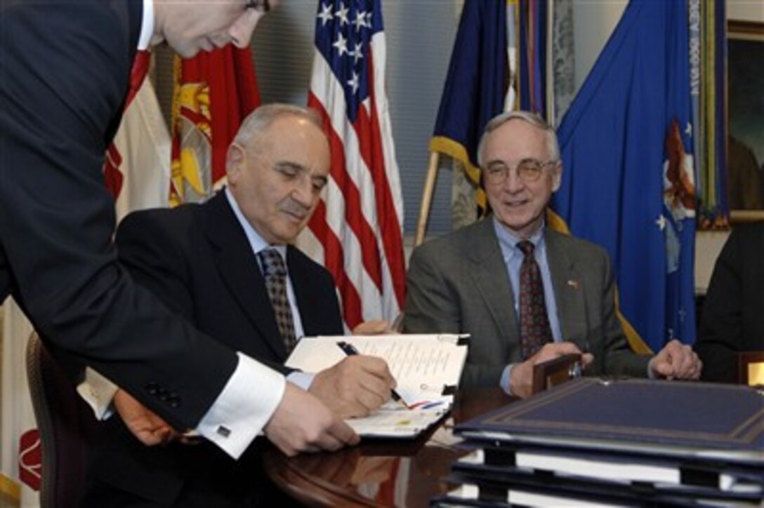 Deputy Secretary of Defense Gordon England (right) and Turkish Minister of Defense Mehmet Gonul (left) sign a Memorandum of Understanding on the Joint Strike Fighter program in the Pentagon on Jan. 25, 2007.  The memorandum concerns details of future cooperation in the production, sustainment, and follow-on development of the aircraft program.  DoD photo by Helene C. Stikkel.  (Released)
