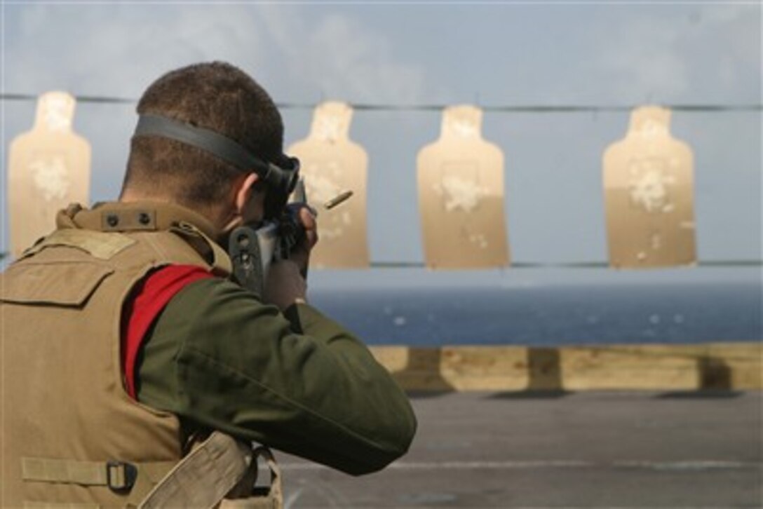A U.S. Marine from Marine Medium Helicopter Squadron-264, 26th Marine Expeditionary Unit, aims at targets during an enhanced marksmanship program range on the flight deck of USS Bataan at sea, Jan. 12, 2007. The range featured unconventional shooting courses of fire.