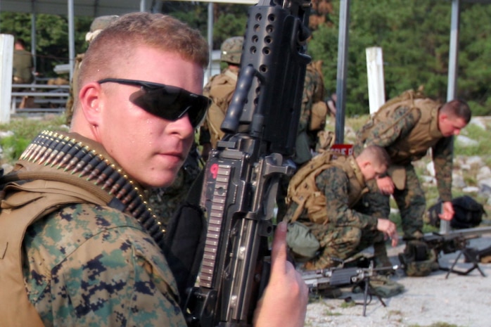 Pfc. Matt Brock, Battalion Landing Team 1st Battalion, 6th Marine Regiment, Headquarters and Support radio operator, waits for his turn on the M249 Squad Automatic Weapon range on Fort Pickett, Va., Aug. 27. After arriving at the battalion less than a month ago, he jumped at the chance to become a SAW gunner.