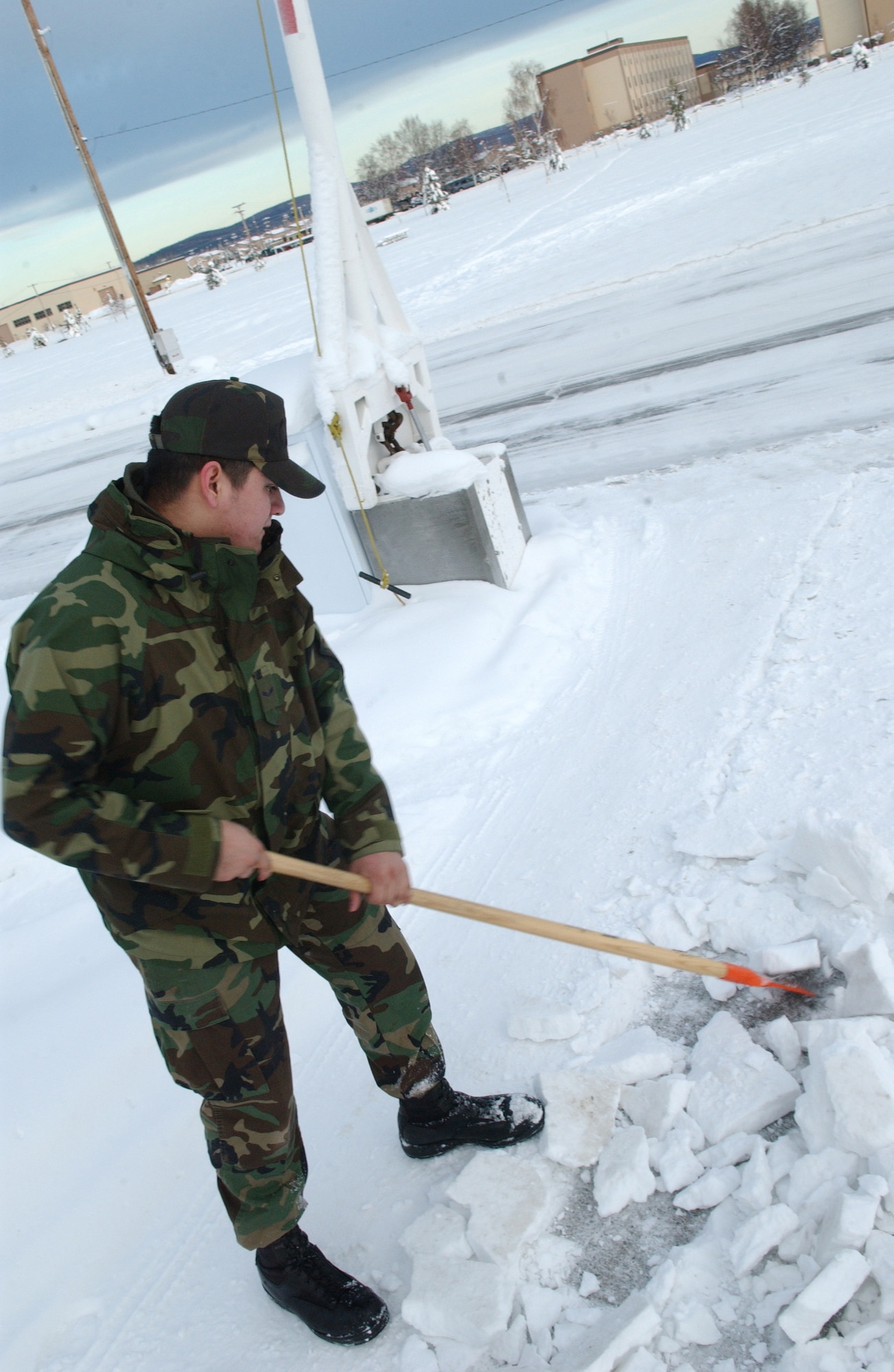 EIELSON AIR FORCE BASE, Alaska -- 354 Civil Engineer Squadron's Airman First Class Catlin Goodrich breaks away frozen ice in front of his Dormitory on Jan 30, 2007. A1C Goodrich is on Bay Orderly this week which consists of keeping the inside and outside of the dormitory in clean and working order, during the winter a lot of the time is spent shoveling snow to make safer paths to walk on. 
(U.S. Air Force photo by Airman Christopher Griffin)