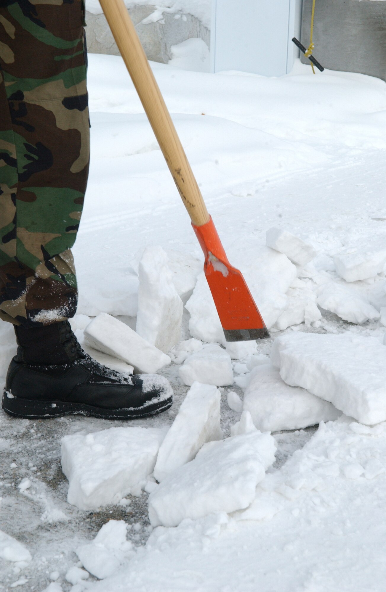 EIELSON AIR FORCE BASE, Alaska -- 354 Civil Engineer Squadron's Airman First Class Catlin Goodrich chips away frozen ice in front of his Dormitory on Jan 30. With ice constantly being frozen to the ground making walk ways slippery, ice picks come in handy to help make paths safer and easier to walk on and is done daily if necessary while on Bay Orderly. 
(U.S. Air Force photo by Airman Christopher Griffin)
