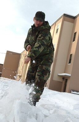 EIELSON AIR FORCE BASE, Alaska -- 354 Civil Engineer Squadron's Airman First Class Catlin Goodrich breaks away frozen ice in front of his Dormitory on Jan 30. A1C Goodrich is on Bay Orderly this week which consists of keeping the inside and outside of the dormitory in clean and working order. During the winter a lot of the time is spent shoveling snow to make safer paths to walk on. 
(U.S. Air Force photo by Airman Christopher Griffin)