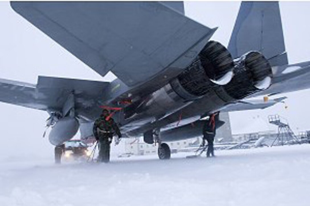 ELMENDORF AIR FORCE BASE, ALASKA -- Maintainers walk along side an F-15e Strike Eagle guiding the aircraft through a blizzard of snow to hangar 2. Even though the inclement weather of winter has the potential to ground aircraft, maintainers must ensure Elmendorf's Fighters have the means to leave at a moments notice. (United States Air Force Photo by Senior Airman Garrett Hothan)

