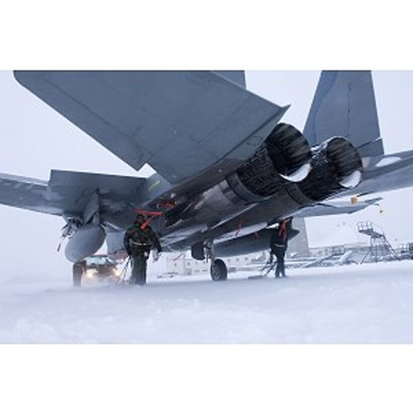 ELMENDORF AIR FORCE BASE, ALASKA -- 12th maintainers walk along side an F-15e Strike Eagle guiding the aircraft through a blizzard of snow to hangar 2. Even though the inclement weather of winter has the potential to ground aircraft, maintainers must ensure Elmendorf's Fighters have the means to leave at a moments notice. (United States Air Force Photo by Senior Airman Garrett Hothan)
