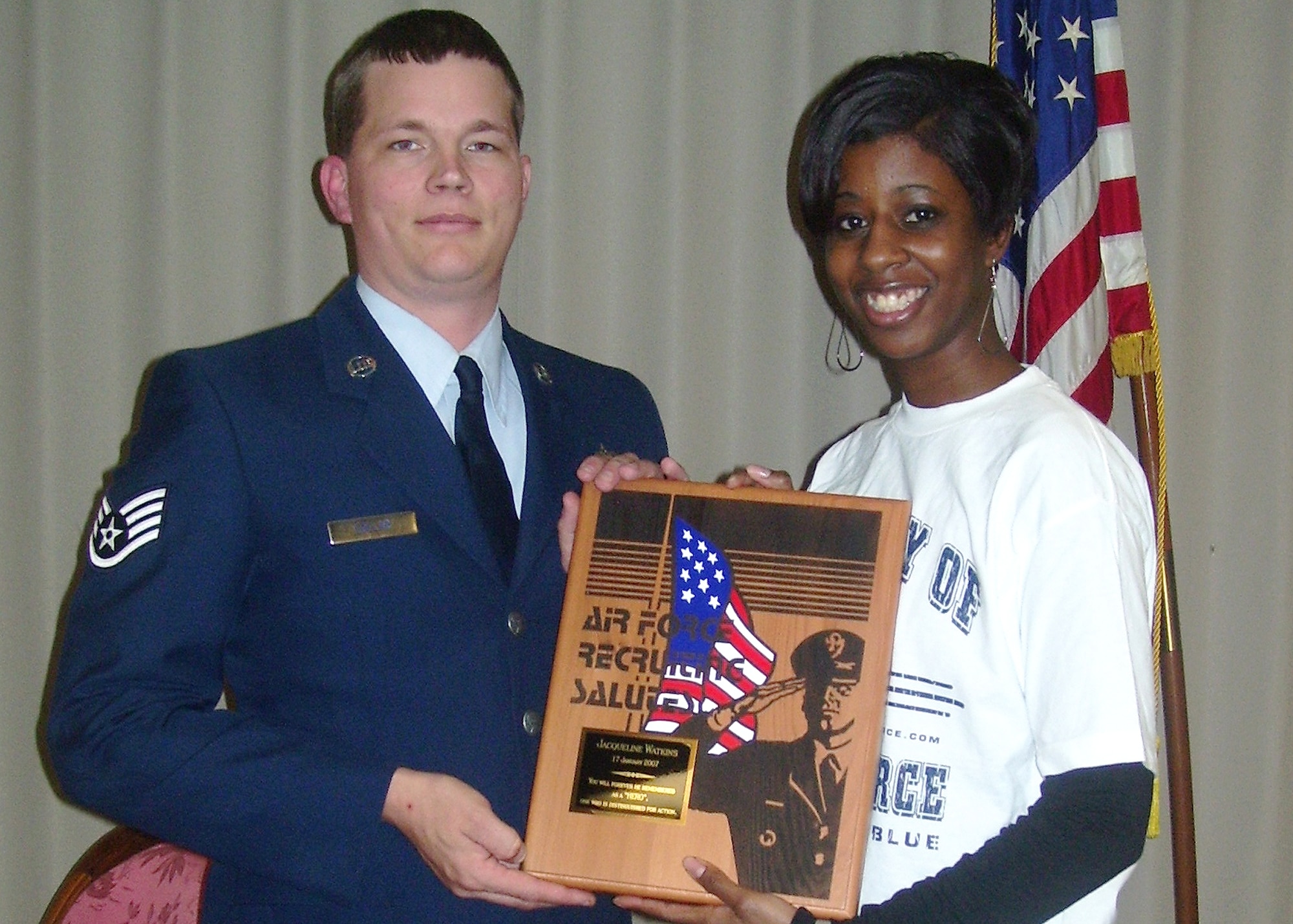 Jacqueline Watkins, Air Force Delayed Entry Program member, and her recruiter Staff Sgt. Robert Lollar, 331st Recruiting Squadron, show the Air Force Recruiting Salutes award the DEPper was awarded Jan. 18 for her demonstration of bravery and compassion by helping to save a man's life Dec. 27. (Enhanced U.S. Air Force photo)