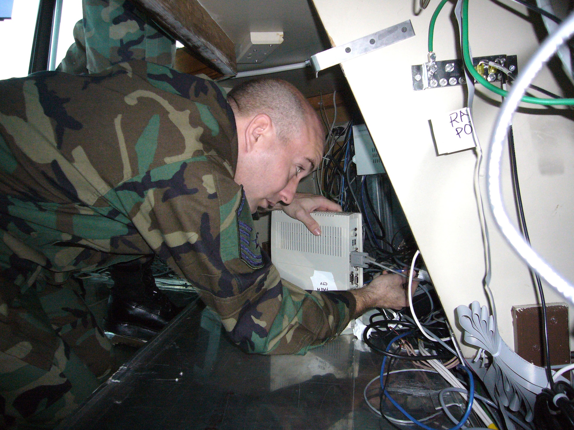 Master Sgt. Robert Stein disconnects communication equipment for the air traffic controllers' relocation to a portable tower Jan. 10 at Ramstein Air Base, Germany. Sergeant Stein is assigned to the 435th Communications Squadron and is assisting in the Ramstein AB control tower renovation. (U.S. Air Force photo/Capt. Erin Dorrance) 