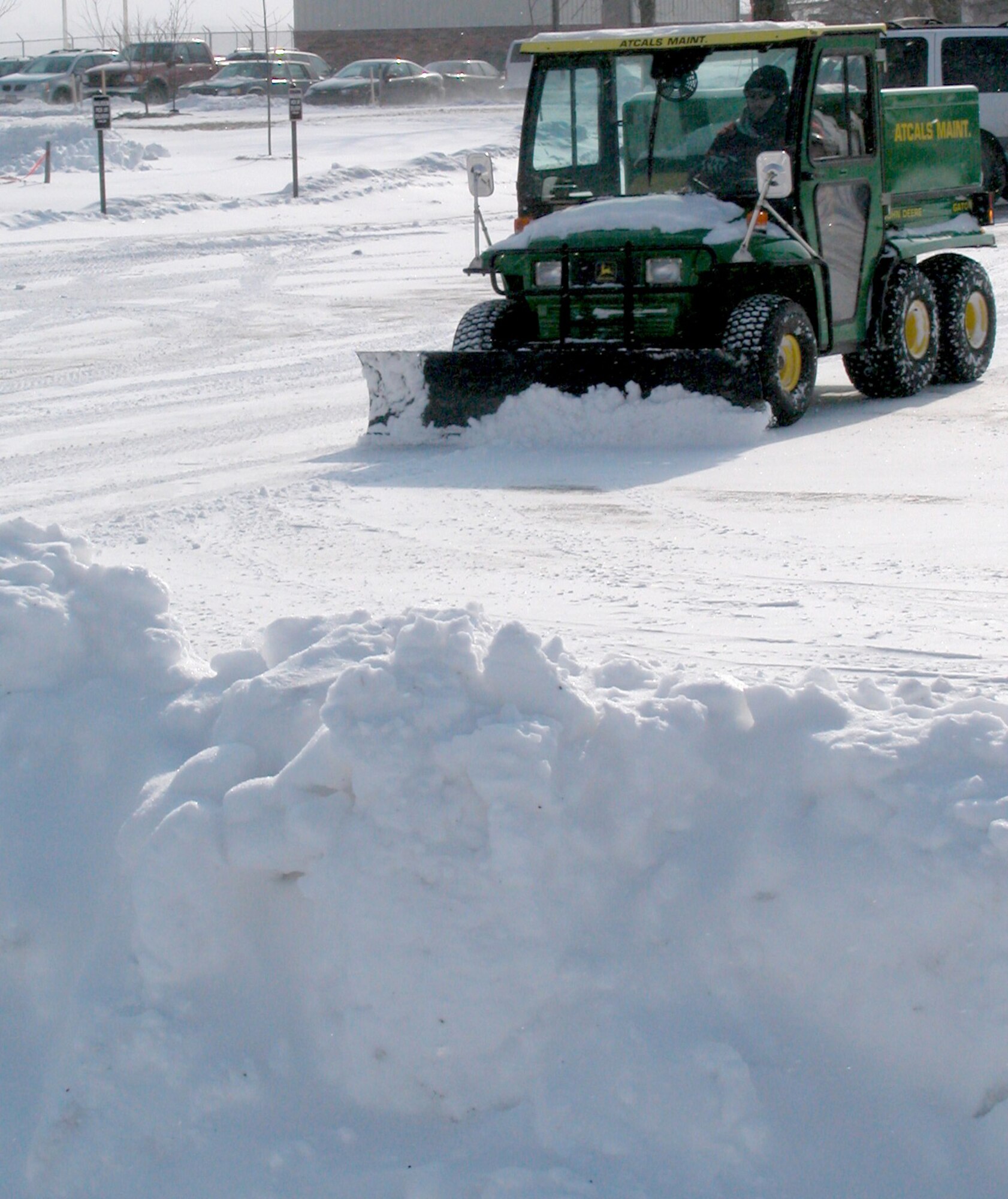 GRISSOM AIR RESERVE BASE, Ind., -- David Yeager, an electronics technican with the 434th Communications Squadron, plows snow outside the communications building on Jan. 30, following a winter storm that hit the north-central Indiana area. Snow and high winds kept personnel busy clearing the flightline, parking ramps, as well as pedestrian thoroughfares and parking areas. (U.S. Air Force photo/Tech. Sgt. Doug Hays)