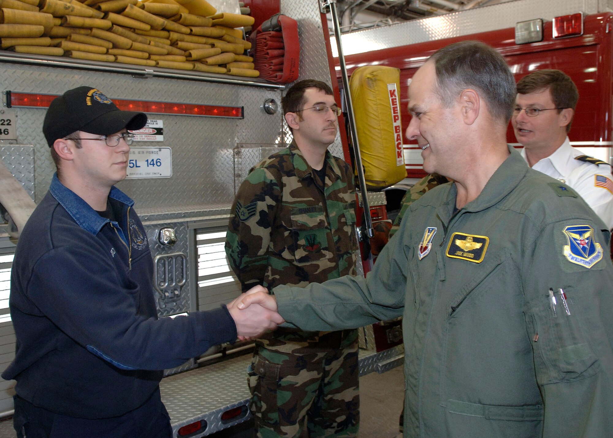 Brig. Gen. Joseph Mudd, 12th Air Force and Air Forces Southern vice commander, tours the Ellsworth Fire Department while visiting here Jan. 25 and 26 and shakes hands with Jesse Piatt, 28th Civil Engineer Squadron firefighter. In his two day visit, General Mudd toured the installation, spoke at the 28th Bomb Wing Annual Awards Banquet and shared his thoughts about current operations and the future of the Air Force with Ellsworth's Airmen.
