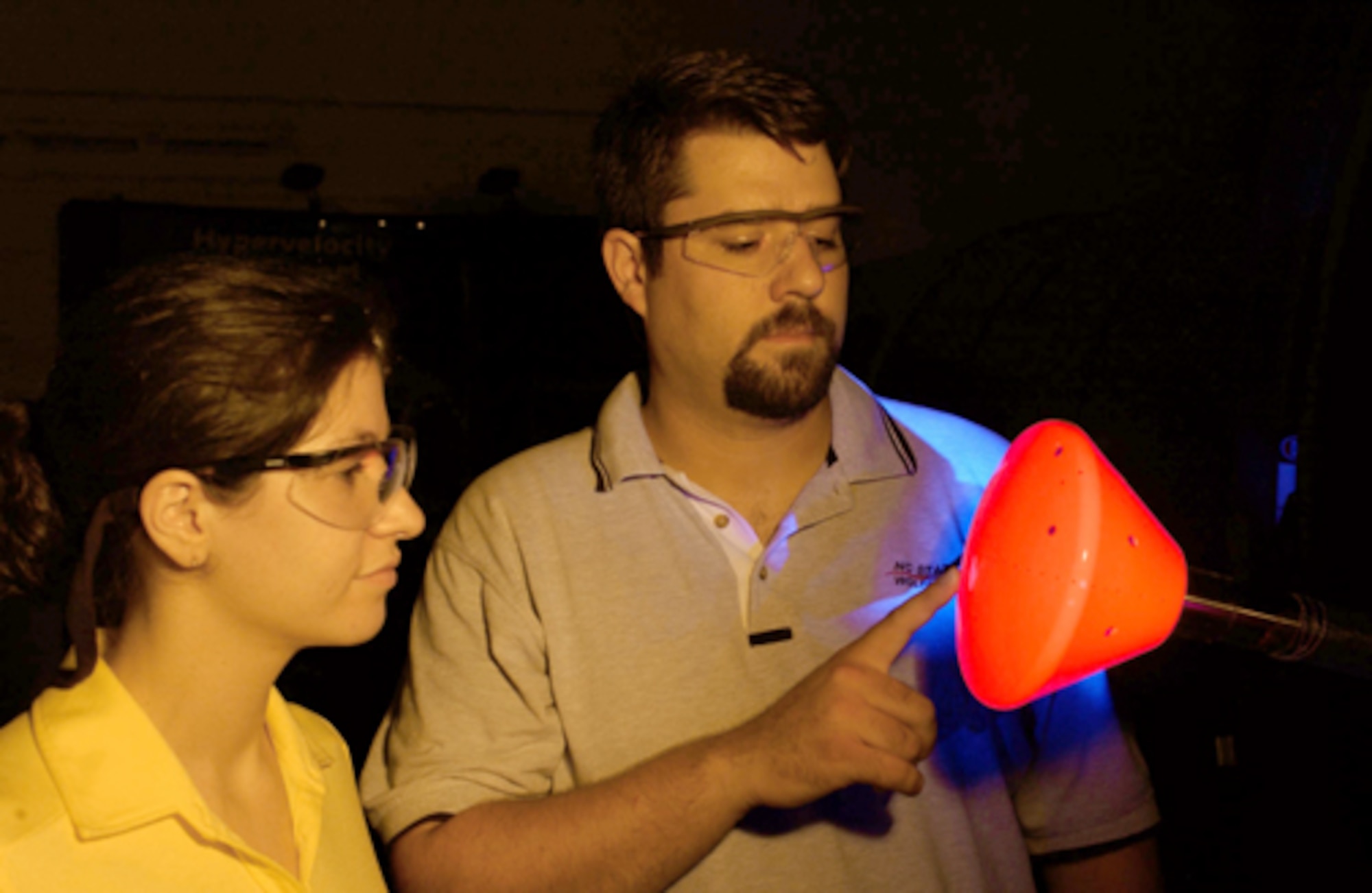 University of Maryland graduate student Inna Kurits and Tunnel 9 ATA project engineer Joe Norris examine the illuminated TSP coating on the NASA CEV model prior to a run. (U.S. Air Force photo)