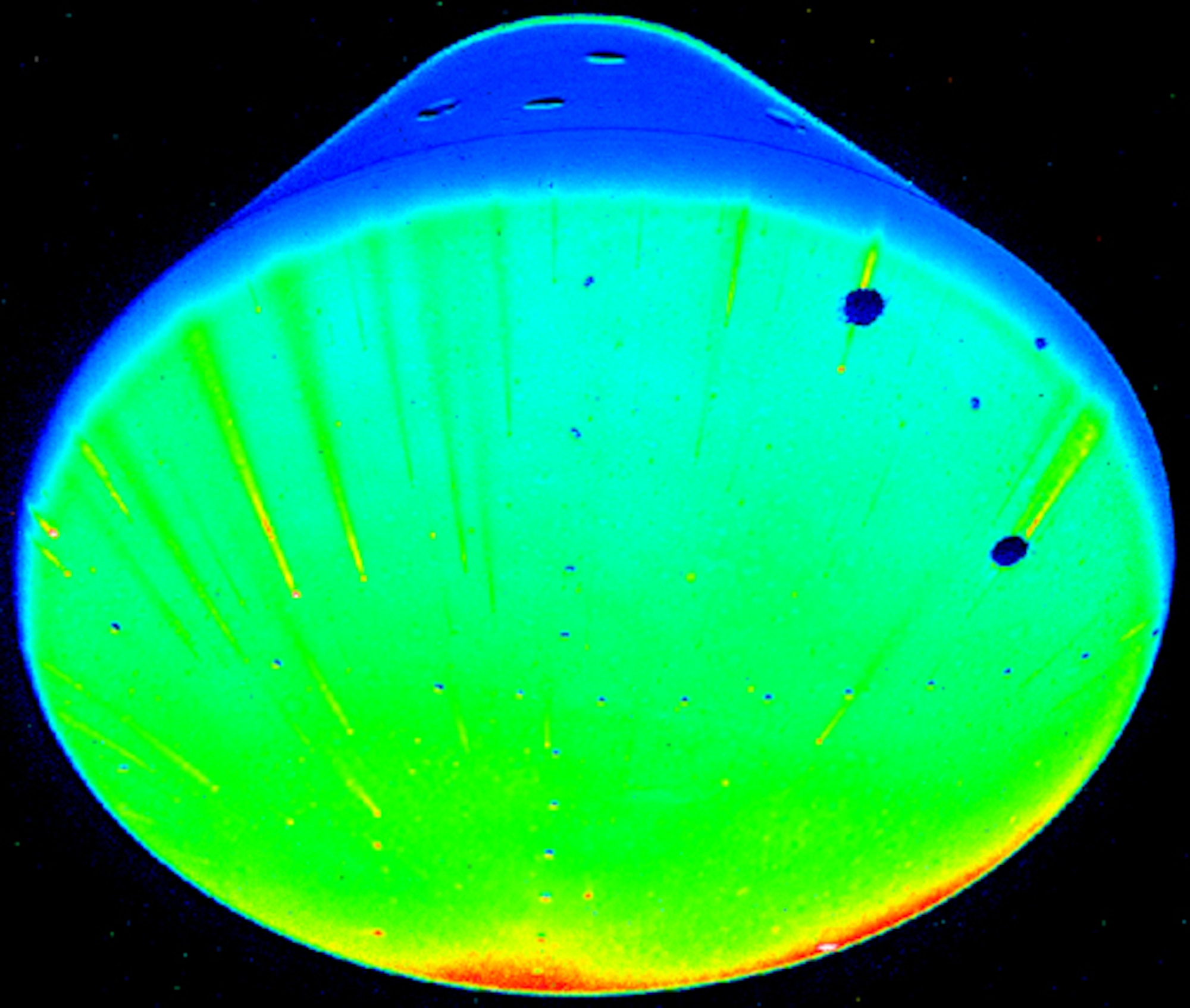 Temperature sensitive paint fluoresces on the surface of the Crew Exploration Vehicle’s heat shield during a Mach 10 run at Tunnel 9. (U.S. Air Force photo)
