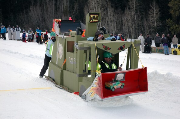 The 25-foot Snow Bull from Schriever AFB plows down the slope Jan. 27 at Keystone. The sled, built by Airmen and civilians from the 50th Civil Engineer Squadron at Schriever, won the Most Creative Design award. (U.S. Air Force photo by Steve Brady)