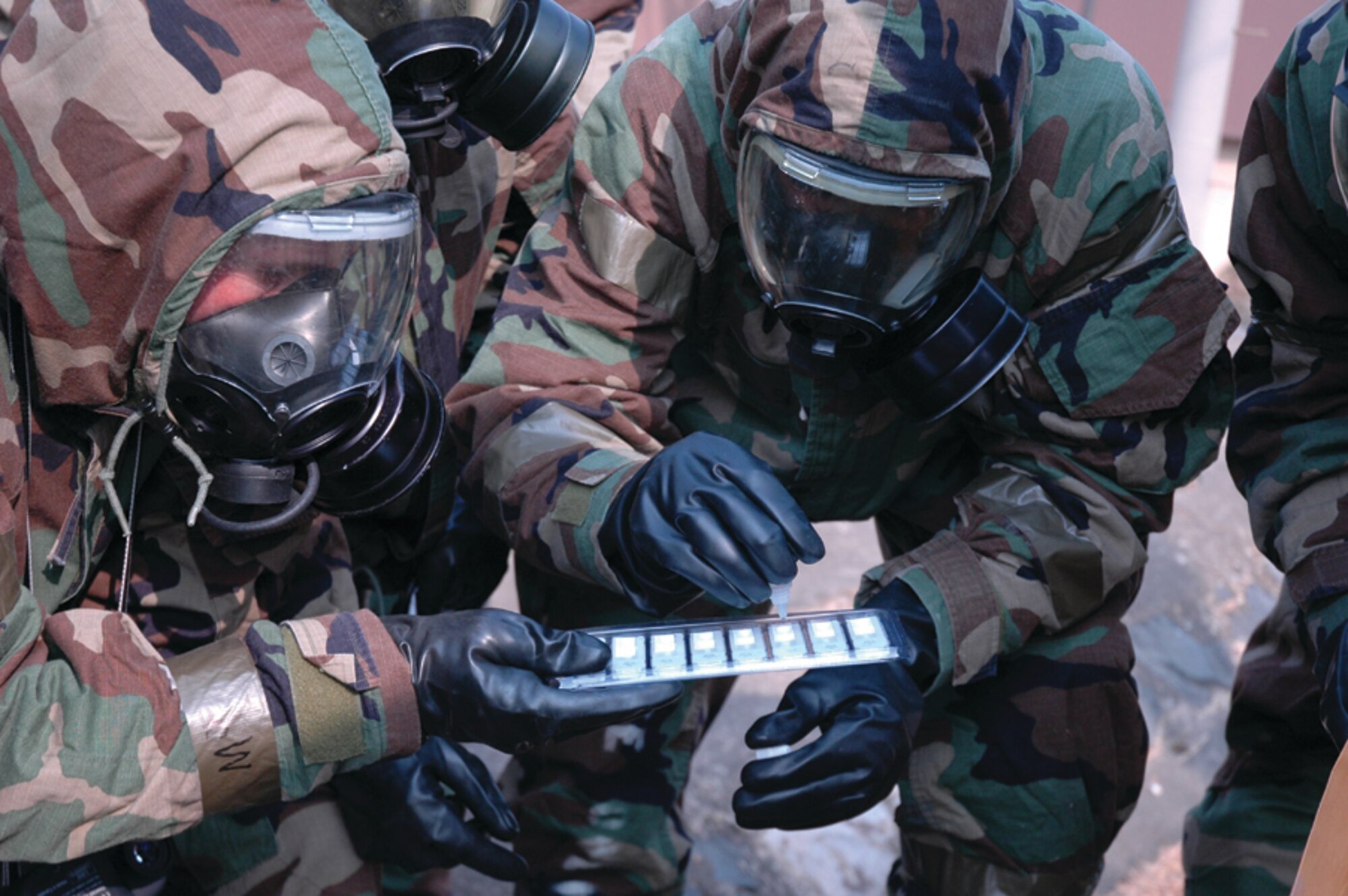 OSAN AIR BASE, Republic of Korea --  People in the Readiness Support Team training class check the results of a M-256 Chemical Agent Detection Kit sample.The class took place over two days and ended with an extensive practical exercise. (U.S. Air Force photo by Senior Airman Brok McCarthy)