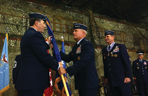 OSAN AIR BASE, Republic of Korea --  Gen. Paul V. Hester, Pacific Air Force Command commander, hands the 7th Air Force guidon to Lt. Gen. Stephen G. Wood, the new 7th Air Force commander, as Lt. Gen. Garry R. Trexler, the former commander, looks on Monday in the 5th Reconnaissance Squadron Blackcat hangar. Lt. Gen. Trexler is retiring after a 36 year career in the Air Force. (U.S. Air Force photo by Senior Airman Eunique Stevens)