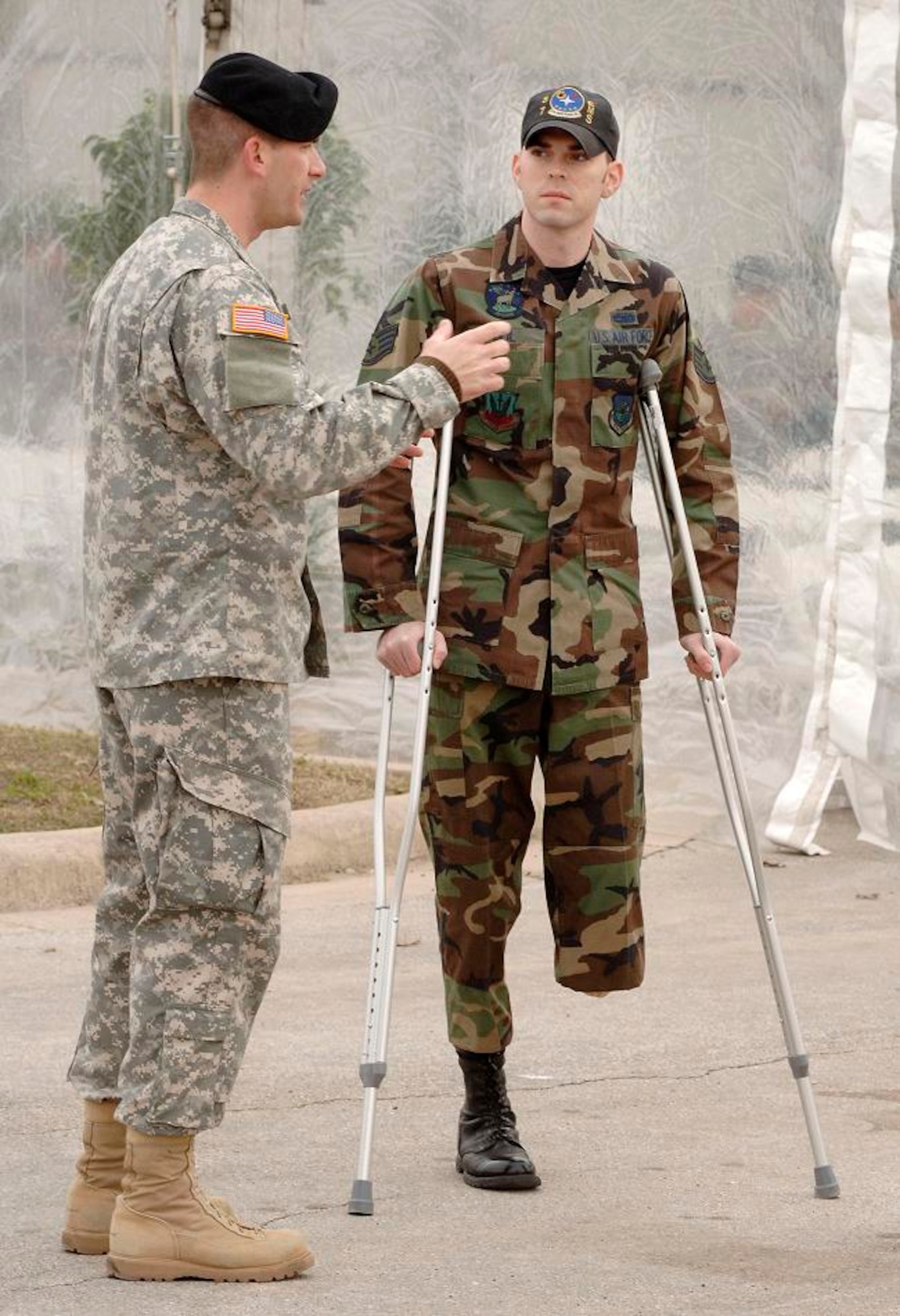 Staff Sgt. Justin Beil is escorted by Army Capt. Brian Freideline from Brooke Army Medical Center before the ceremony to open the Center for the Intrepid, a rehabilitation center for amputees and burn victims.  Sergeant Beil is assigned to the 59th Medical Wing at Lackland Air Force Base, Texas, and will use the new facility on an out-patient basis. (U.S. Air Force photo/Daren Reehl)