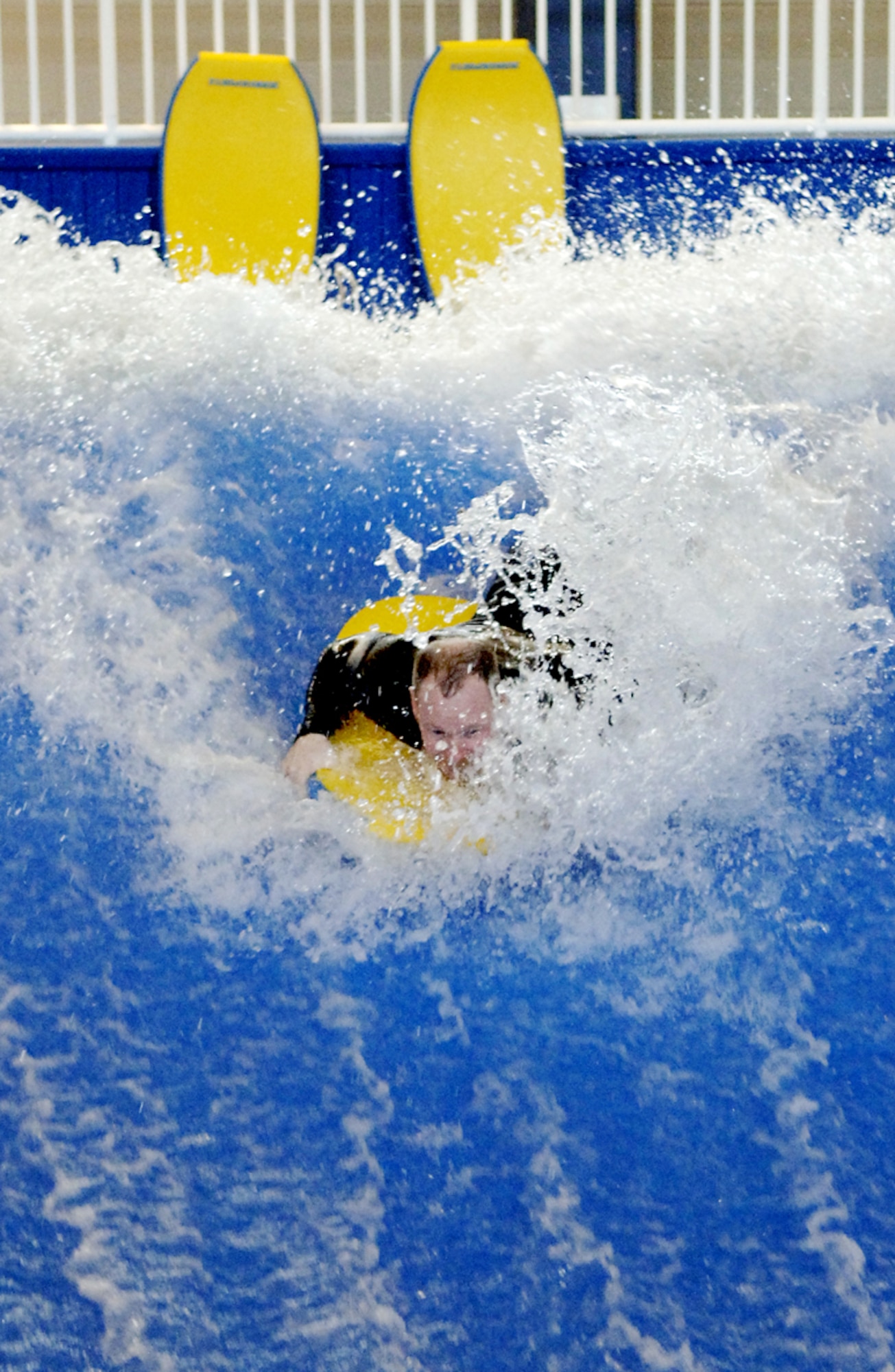 Justin LaFerrer, an occupational therapist, demonstrates the Flowrider, a machine that creates wave action to help injured patients with balance and strengthening exercises at the Center for the Intrepid in San Antonio Jan. 29.  Four floors of state-of-art equipment make the $50 million-dollar facility the only one of its kind in the world. (U.S. Air Force photo/Daren Reehl)