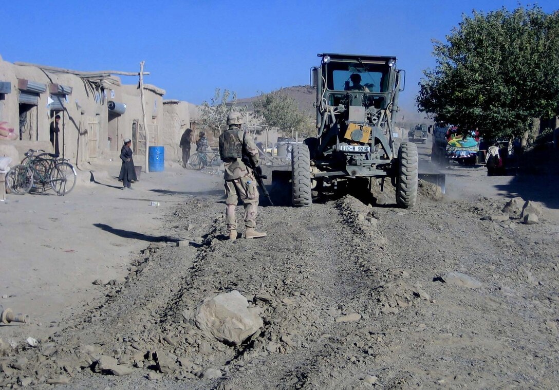 Soldiers build a road through the market town of Shinkay in eastern Afghanistan. Charlie Company, 864th Engineer Combat Battalion (Heavy), Task Force Pacemaker, is deployed to Kandahar, Afghanistan, from Fort Richardson, Alaska. Photo by 1st Lt. Claudia Crossland, USA