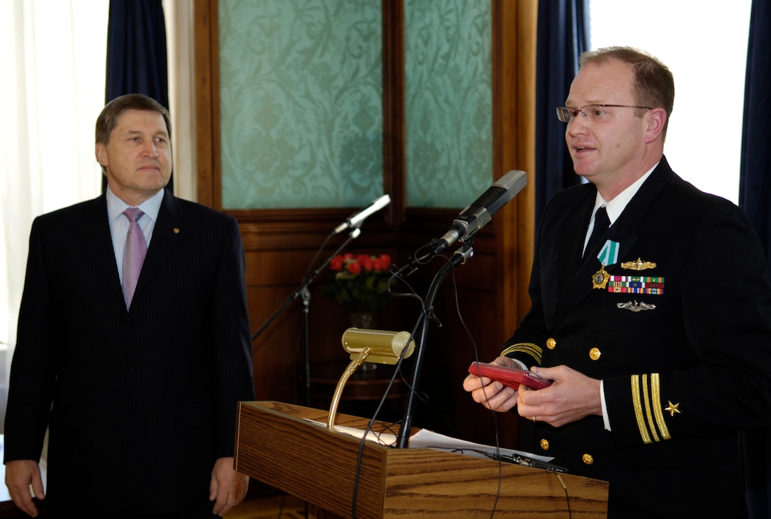 U.S. Navy Lt. Cmdr. Steven Smith speaks to the audience of both ...