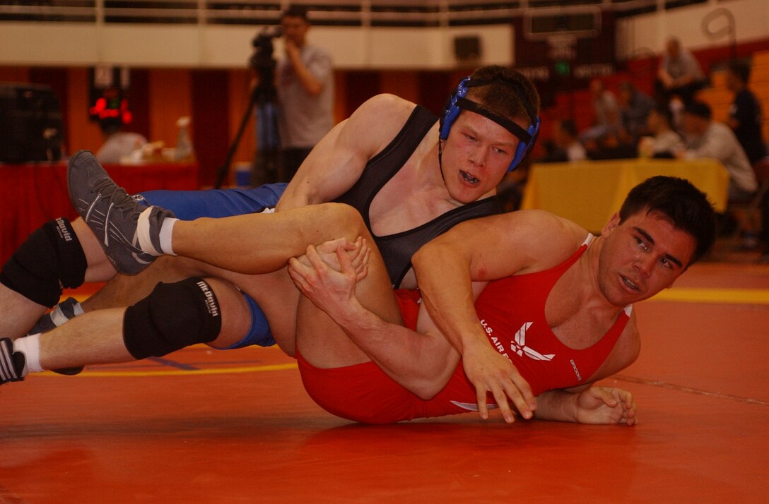 Army Spc. Aaron Holker (top) works a winning combination against Air Force Capt. Ryan Montanez during their 66-kilogram freestyle match in the 2006 Armed Forces Wrestling Championships at Marine Corps Base Camp Lejeune, N.C. Holker won the match to take the gold medal. Photo by Jamie Cameron