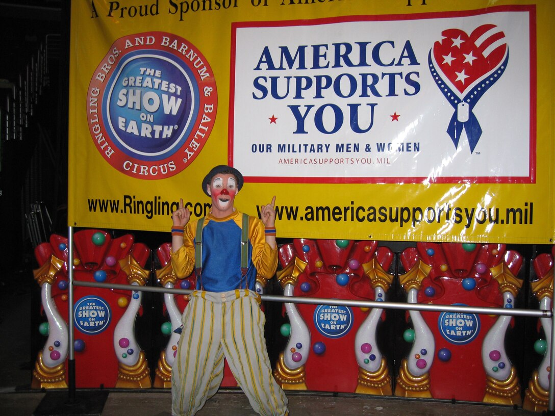 America Supports You welcomed Ringling Bros. and Barnum & Bailey Circus as a corporate member during a kickoff ceremony. Michael Richter, a clown with the circus, poses in front of an ASY sign before the show in downtown Washington, D.C., March 29. Photo by Paul X. Rutz