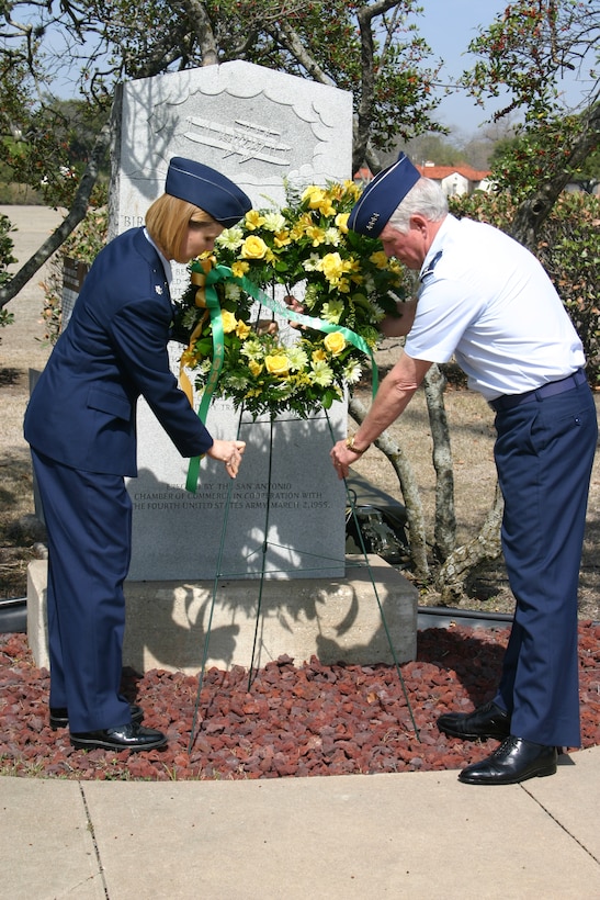 Air Force Gen. William Looney III, commander of Air Education and Training Command at Randolph Air Force Base, Texas, and Lt. Col. Sandra Miarecki, chief of flight operations at Brooks City-Base, Texas, place a memorial wreath during the March 2 ceremony commemorating the 96th anniversary of the first military flight. Photo by Minnie Jones