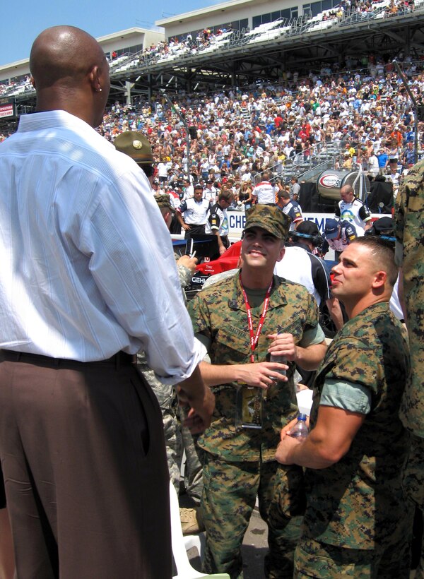 Marine Cpl. Tyler Stover (left) and Lance Cpl. Chris Offringa, both assigned to Company A, 1st Battalion, 24th Marine Regiment, talk with Eddie George, an NFL all-pro running back. Photo by Samantha L. Quigley