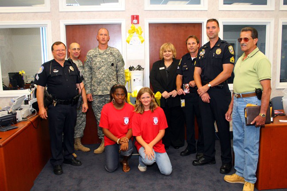 The Fort Pierce and Port St. Lucie, Fla., police athletic leagues, spearheaded by Gary Schwartz, far right, have been collecting cell phones in support of Massachusetts-based Cell Phones for Soldiers. Participating in the effort are, from left, Paul Pearson, Fort Pierce police athletic league master officer; Capt. Danny Robinson, Army recruiting company commander; Staff Sgt. Brian Primmer, Army recruiter; Mary Rose Cuoco, Harbor Federal Bank branch manager; Tim Reilly, Port St. Lucie police athletic league master officer; and Port St. Lucie Officer Staff Sgt. Frank Sabol. PAL participants Tiffany Mathews (kneeling, left) and Ashley Owens also pitched in. Courtesy photo