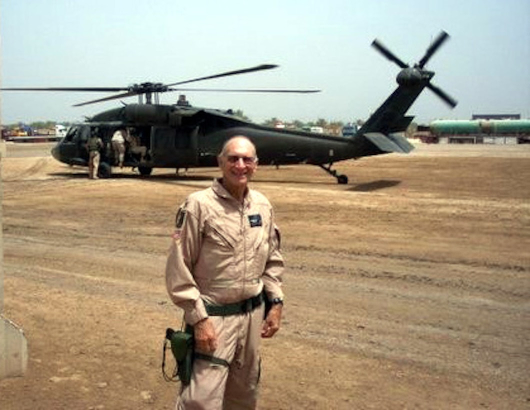 Col. William Bernhard, an Army surgeon, stands in front of a UH-60 Black Hawk helicopter on Forward Operating Base Lima, Iraq, Oct. 15, 2005. Bernhard, 75, is about to deploy to Kabul, Afghanistan, reportedly as the oldest deployed member of America's armed forces. Courtesy photo