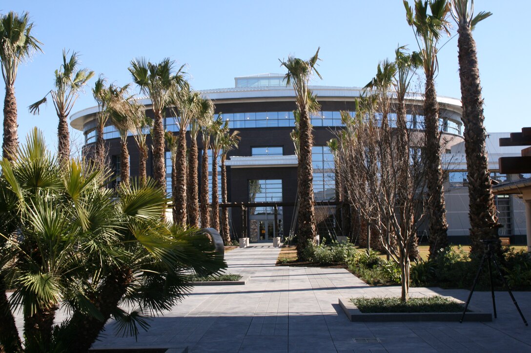 The rear exit from the Center for the Intrepid follows a pathway lined with palm trees, leading to the new Fisher Houses 3 and 4.

