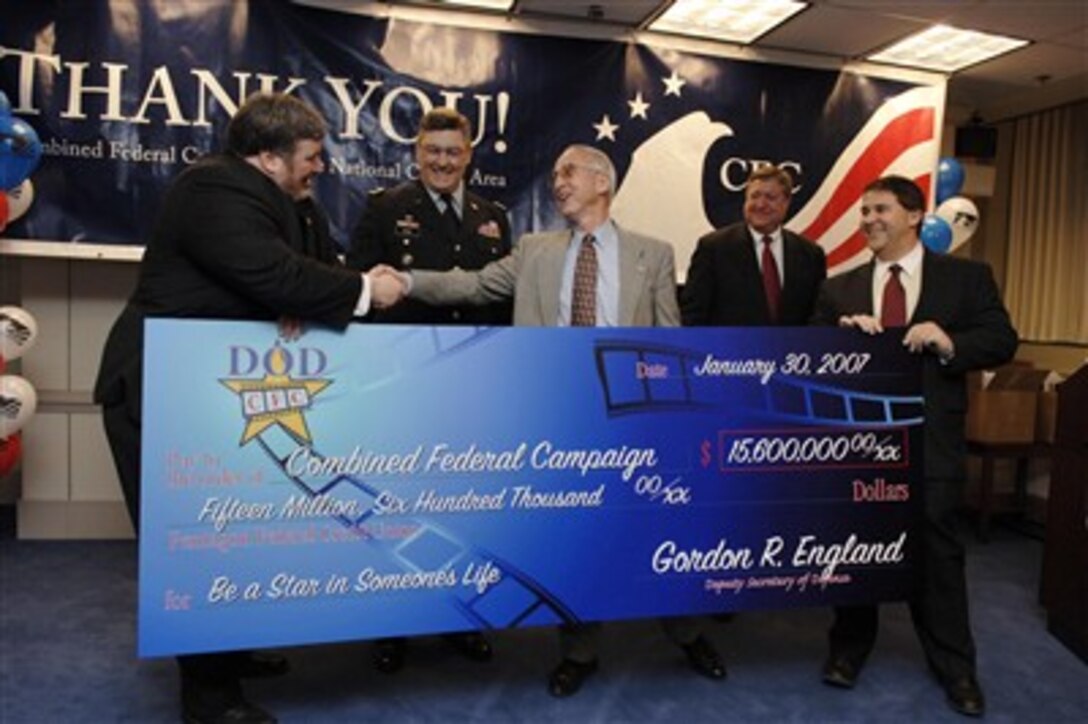 Deputy Secretary of Defense Gordon England (3rd from left) presents a check on behalf of the Department of Defense for $15.6 million to the Director of the National Capital Area Combined Federal Campaign Anthony De Cristofaro (left) in the Pentagon on Jan. 30, 2007.  From left to right, De Cristofaro, Program Executive Officer for Fort Belvoir Brig. Gen. R. Mark Brown, U.S. Army, England, Director of Administration and Management Michael B. Donley, and DoD Combined Federal Campaign Director Lou Torchia.  