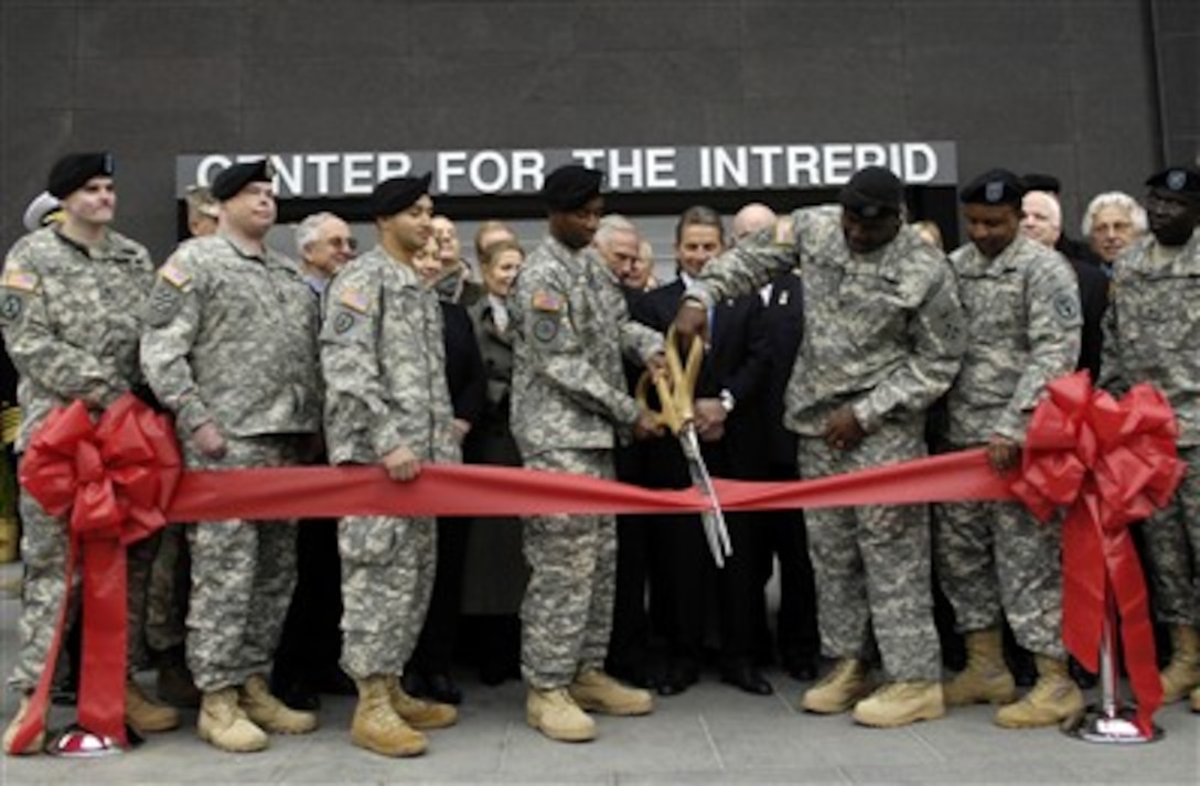 Servicemembers cut the ceremonial ribbon for the Center for the Intrepid, a state-of-the-art physical rehabilitation center and two new Fisher Houses for hospitalized military members' families, at Fort Sam Houston, Texas, Jan. 29, 2007.
