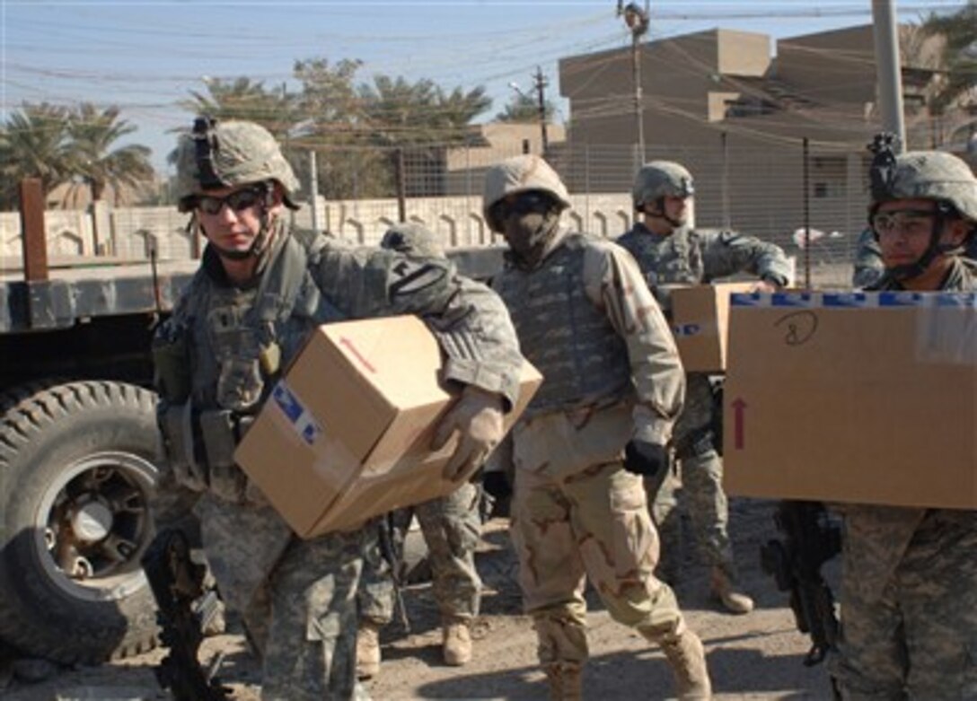 U.S. Army soldiers from 2nd Infantry Division prepare to deliver a clothing donation to a middle school in Baghdad, Iraq, Jan. 23, 2007. 