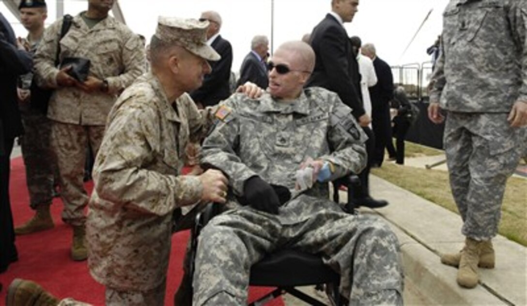 Chairman of the Joint Chiefs of Staff Gen. Peter Pace (left), U.S. Marine Corps, talks with U.S. Army Staff Sgt. Dominguez prior to a dedication ceremony for the Center for the Intrepid and two new Fisher Houses at Fort Sam Houston, Texas, on Jan. 29, 2007.  The Center is a state-of-the-art physical rehabilitation center and the Fisher Houses are for the families of hospitalized military members.  