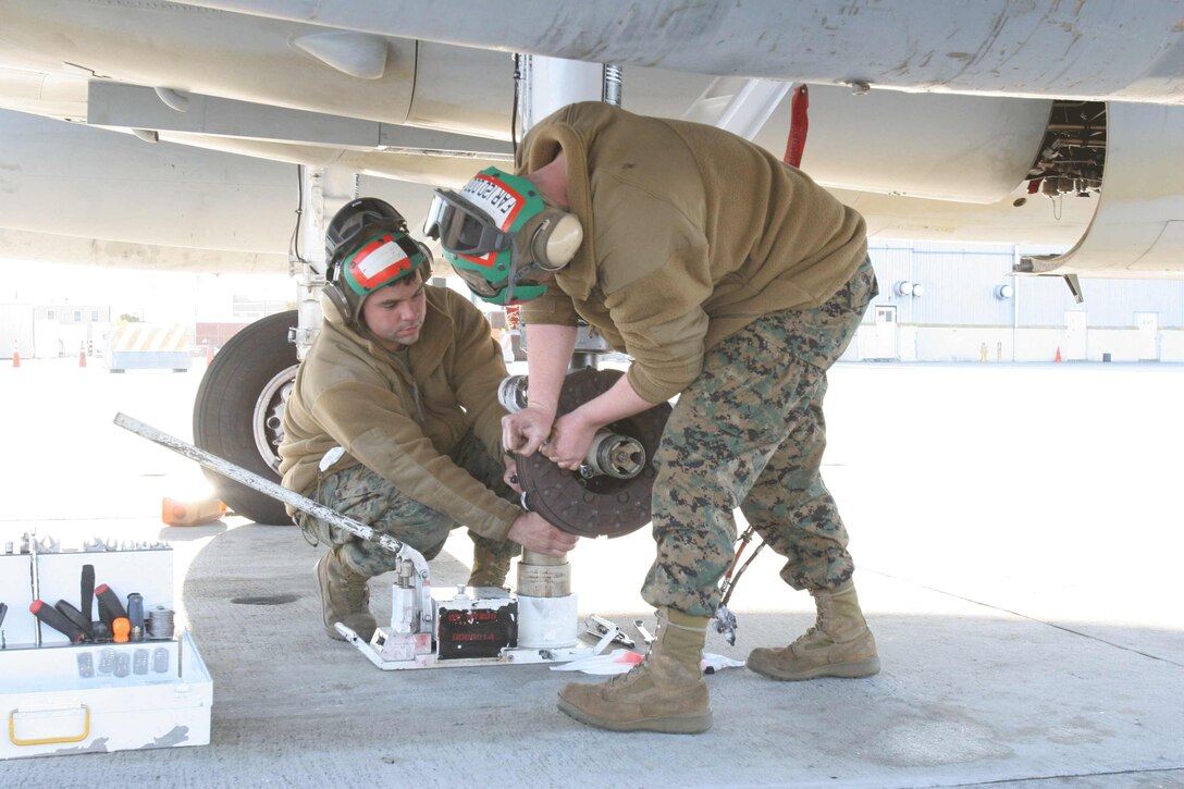 Navy Cmdr. Richard Jadick signs his book 'On Call in Hell' as Marine Capt. Matthew Kutilek, junior Marine officer instructor, The Citadel, watches from behind.