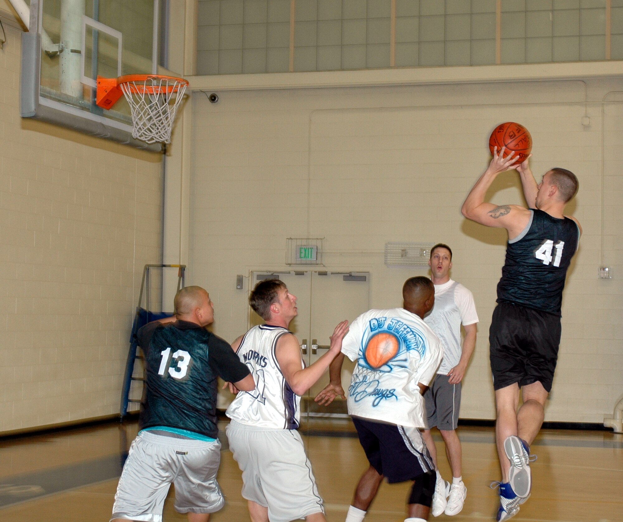 Hunter Meadors, (#41), 60th Aircraft Maintenance Squadron power forward, shoots a jump shot during his team’s 28-21 win over the 60th Aerial Port Squadron Jan. 30.  Meadors was his team’s leading scorer with eight points. (U.S. Air Force photo by Staff Sgt. Candy Knight)