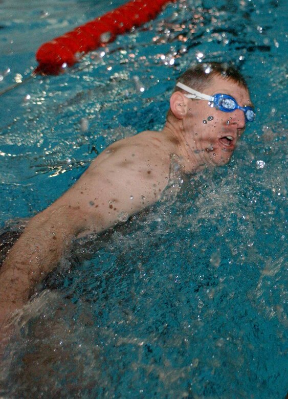 EIELSON AIR FORCE BASE, Alaska--Airmen compete in a swim relay during a four-person team competition at the fitness center. More than 400 Airmen and their families attended the X-Treme Winter Challenge hosted by the 354th Services Squadron and BASE 24/7. (U.S. Air Force photo by Senior Airman Rachel Walters)                               