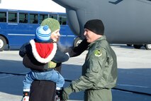 MINOT AIR FORCE BASE, N.D. -- First Lt. Sean Odom, 23rd Bomb Squadron, greets his wife Allison and son Theo after returning from a deployment Jan. 29. Lieutenant Odom and other Minot Airmen were met by friends and family upon arriving home from a five-month deployment to Andersen Air Force Base, Guam. (U.S. Air Force photo by Airman 1st Class Christopher Boitz)