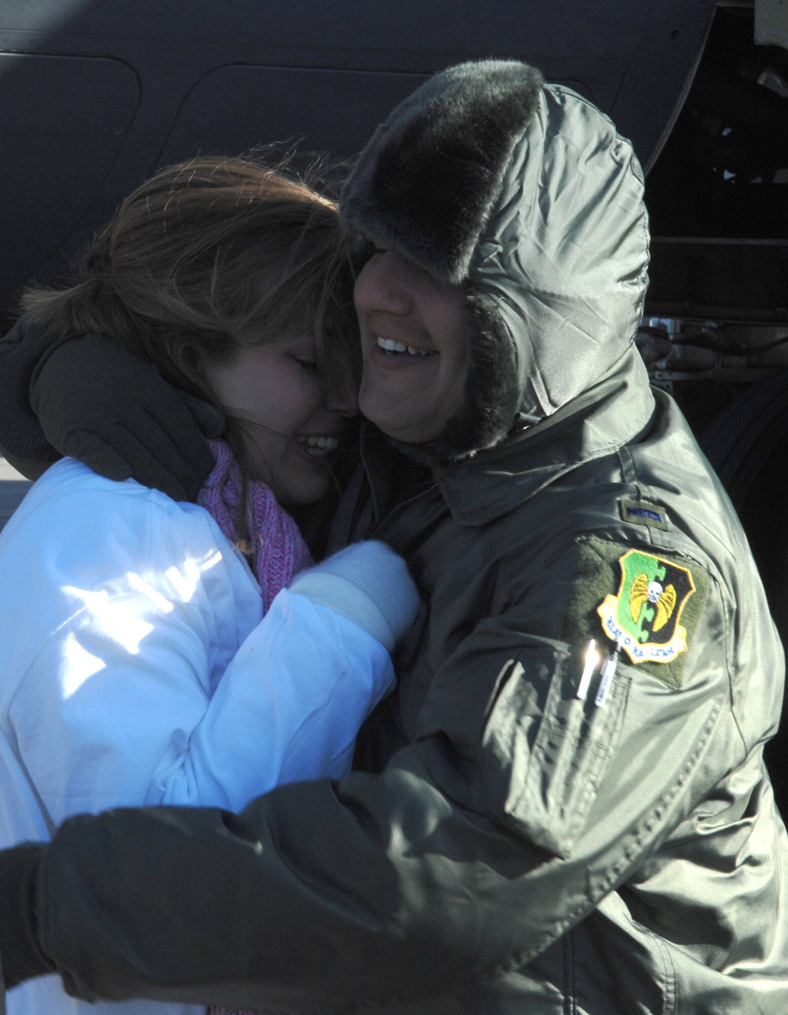 MINOT AIR FORCE BASE, N.D. -- First Lt. Patrick Godinez, 23rd Bomb Squadron, hugs his wife Melissa after returning from a deployment Jan. 29. Lieutenant Odom and other Minot Airmen were met by friends and family upon arriving home from a five-month deployment to Andersen Air Force Base, Guam. (U.S. Air Force photo by Airman 1st Class Christopher Boitz)