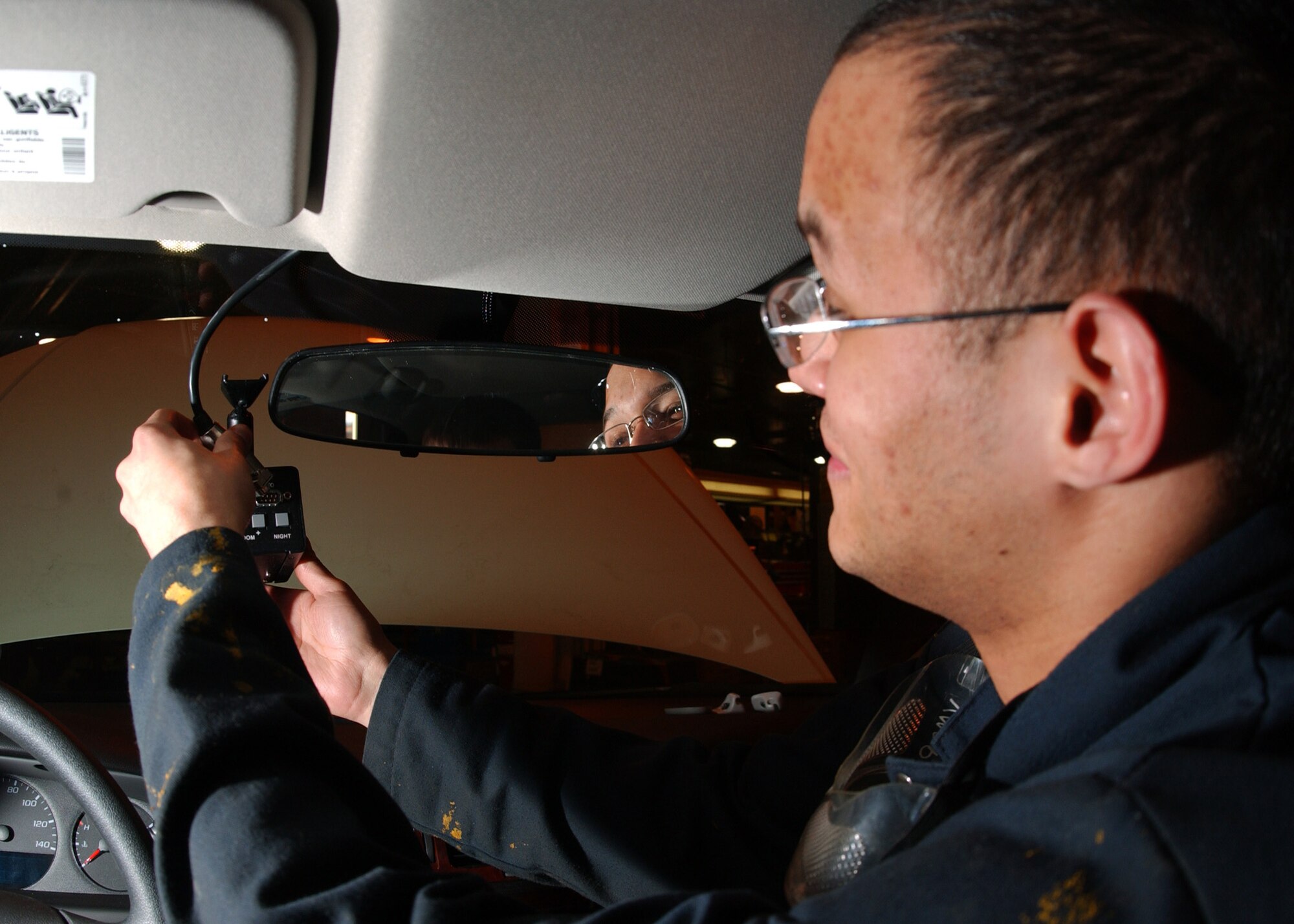 EIELSON AIR FORCE BASE, Alaska -- Airman First Class Angel Suarez, 354th Logistic Readiness Squadron installs a video surveillance system into a Security Forces patrol car at Vehicle Operations Building here on Jan. 30. This is the first video surveillance system being installed in a patrol car on Eielson AFB. 
(US Air Force Photo by Airman Jonathan Snyder)