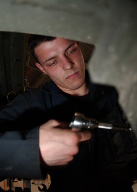 EIELSON AIR FORCE BASE, Alaska -- Airman Rodney Ney, 354th Logistic Readiness Squadron unscrews a bolt on a 25K Loader at Vehicle Operations Building here on Jan. 30. Airman Ney must de-assemble the whole machine so it can be shipped off to be rebuilt. 
(US Air Force Photo by Airman Jonathan Snyder)