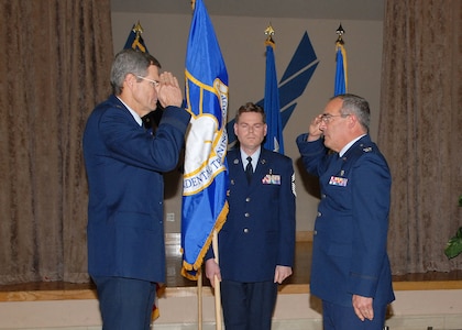 Brig. Gen. David Young, commander of the 59th Medical Wing, left, returns the salute of Col. Don Sedberry as the colonel assumes command of the newly formed 59th Dental Training Group during a formal ceremony Jan. 25 at the Gateway Club on Lackland Air Force Base, Texas. Chief Master Sgt. Noble Lisenbee, superintendent of the 59th DTRG, stands behind them with the group flag. (USAF photo by Robbin Cresswell)